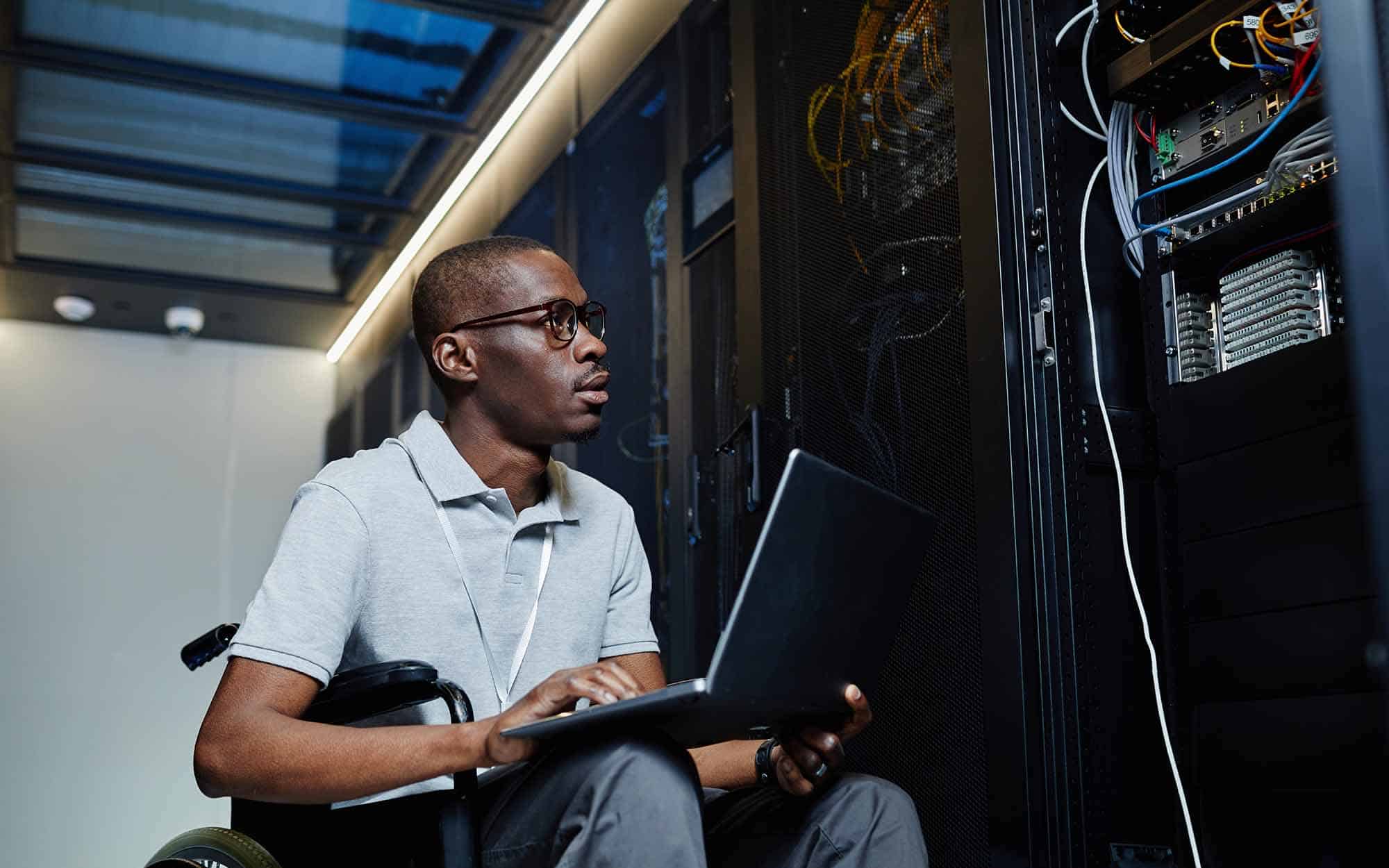 Portrait of young man working as IT technician and managing server network